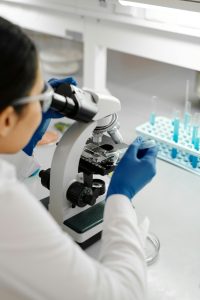 Researcher with microscope